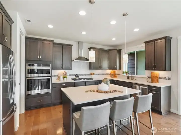 Expansive island seating creates the perfect gathering place for guests.