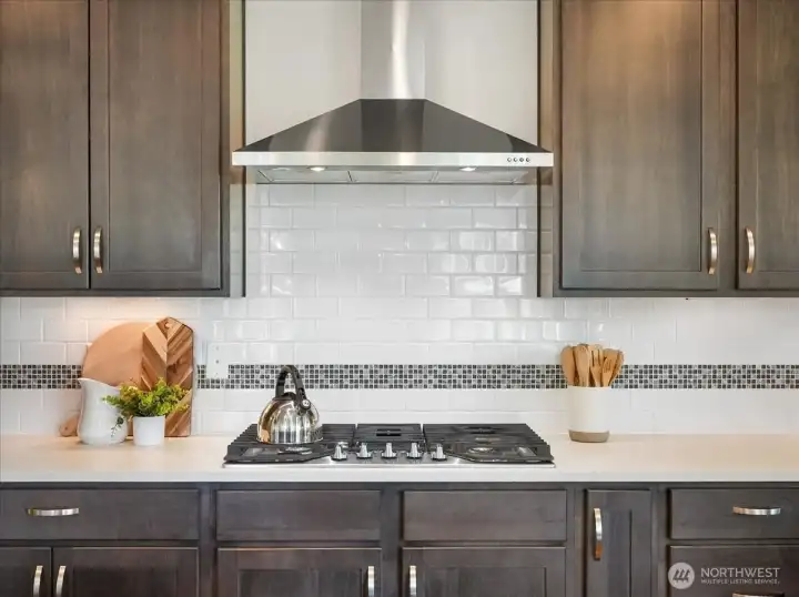 Premium appliances and granite countertops elevate this chef-inspired space.