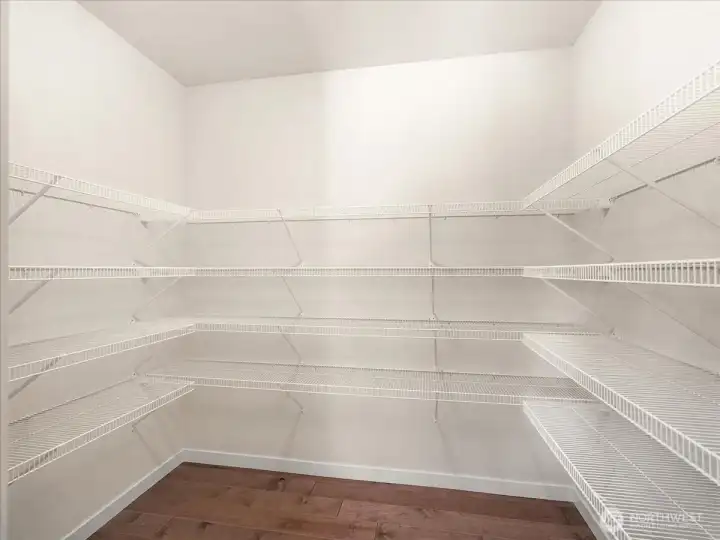 Spacious walk-in pantry offers convenience for everyday living and entertaining.