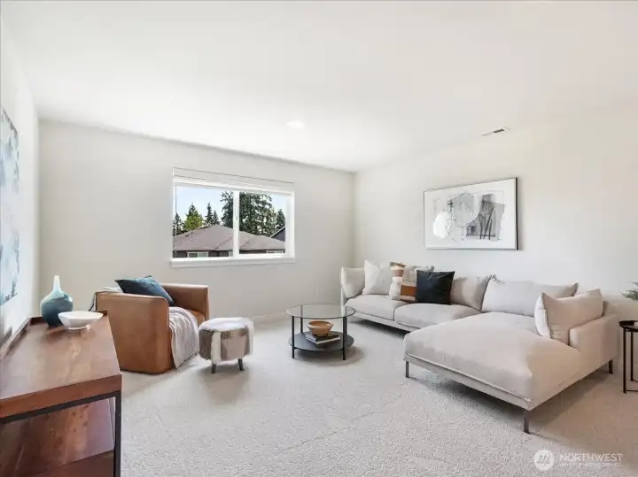 Expansive upstairs den ideal for relaxing, entertaining, or movie nights.