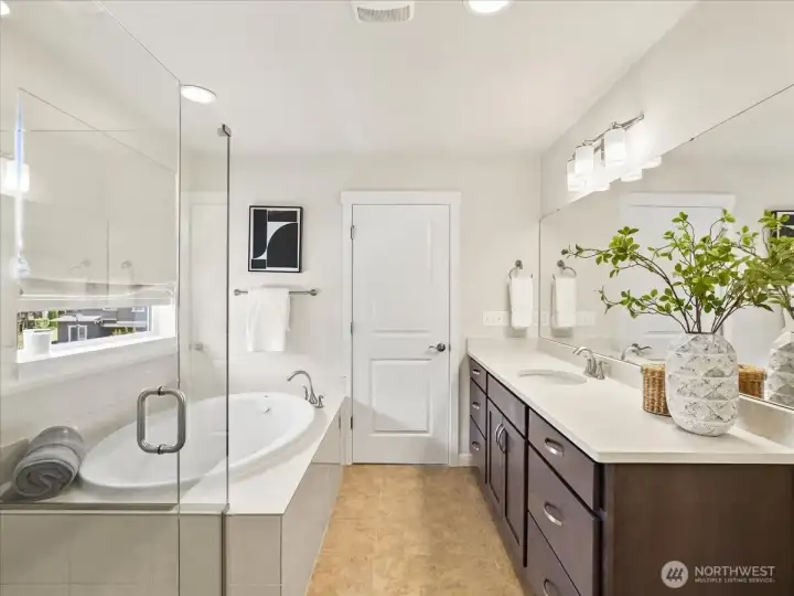 Relax and unwind in the luxurious soaking tub and expansive walk-in shower.