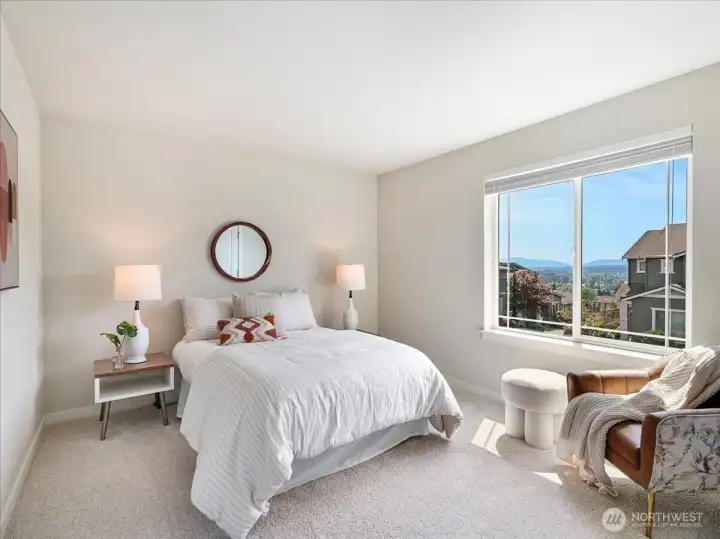 Wake up to breathtaking Mount Rainier views from this serene bedroom.
