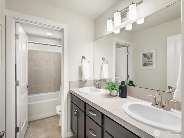 Spacious upstairs bathroom thoughtfully designed with a separate tub and toilet area.