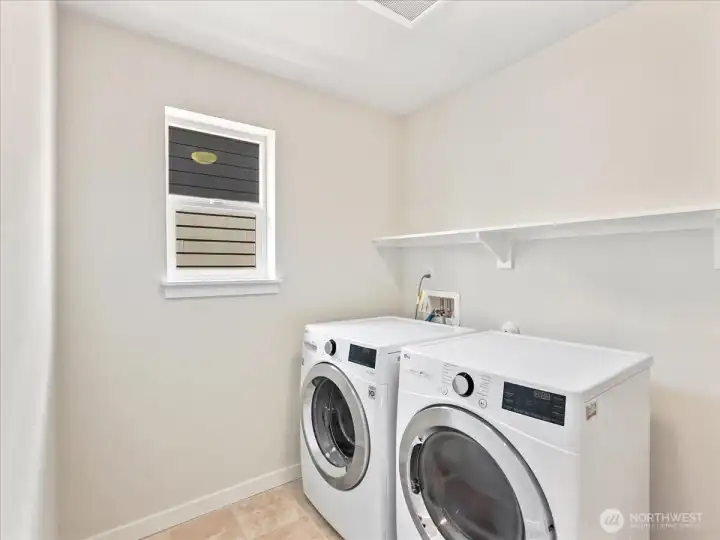 Convenient upper-level utility room designed for effortless everyday functionality.