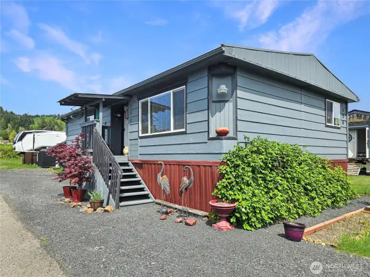 Covered front entry to invite your into the home. Corner lot with room to garden.
