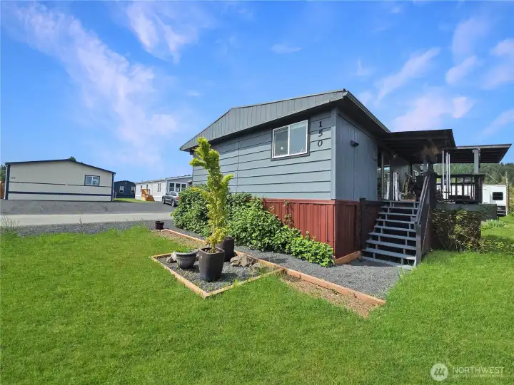View of the covered back deck and front yard area.
