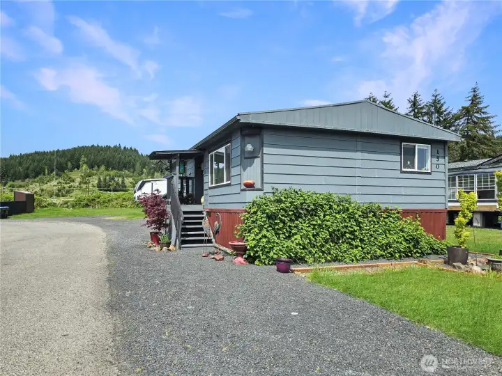Parking strip along the yard. Home has a newer rolled roofing material.