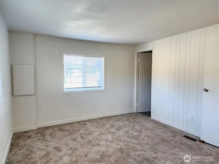 Primary bedroom with attached bath shown without furnishings when the prior owner purchased the home.