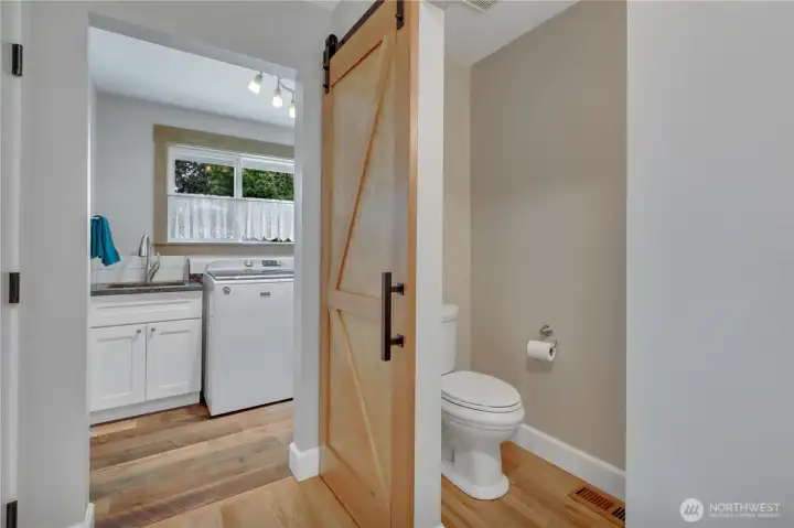 Laundry room with utility sink and showing custom door at 1/2 Bath Laundry room with utility sink and showing custom door at 1/2 Bath