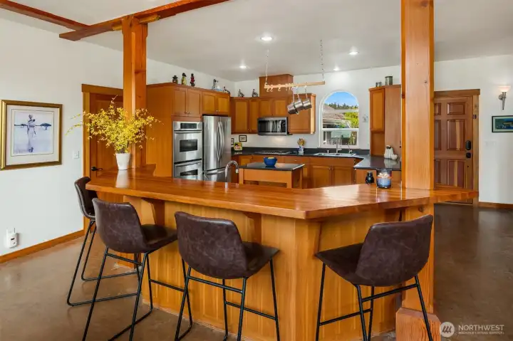 The large eating bar comfortably seats six and is ideal for casual dining, conversation, and enjoying the home's premium surround sound. The large eating bar comfortably seats six and is ideal for casual dining, conversation, and enjoying the home's premium surround sound.