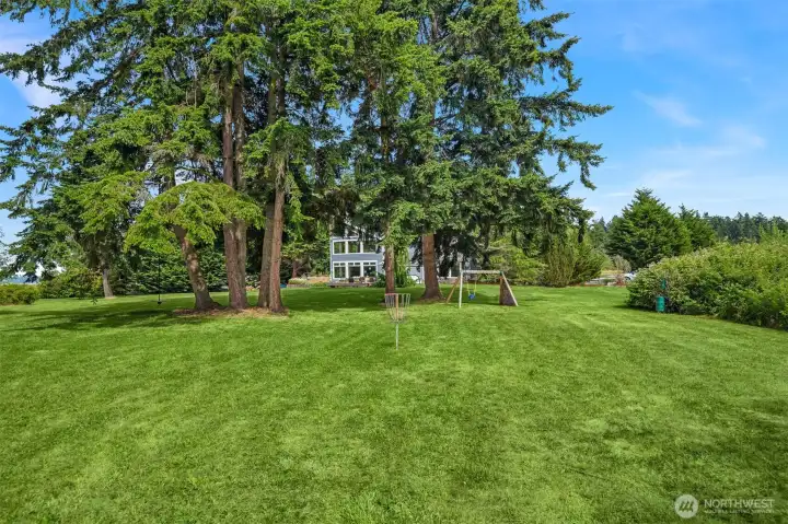 With 2.4 level acres, there's endless room for lawn games, picnics, and unforgettable family celebrations. With 2.4 level acres, there's endless room for lawn games, picnics, and unforgettable family celebrations.