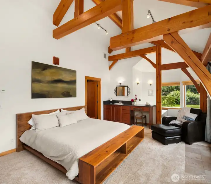 The main-level primary suite offers a large soaking tun and vaulted and beamed ceilings. The main-level primary suite offers a large soaking tun and vaulted and beamed ceilings.
