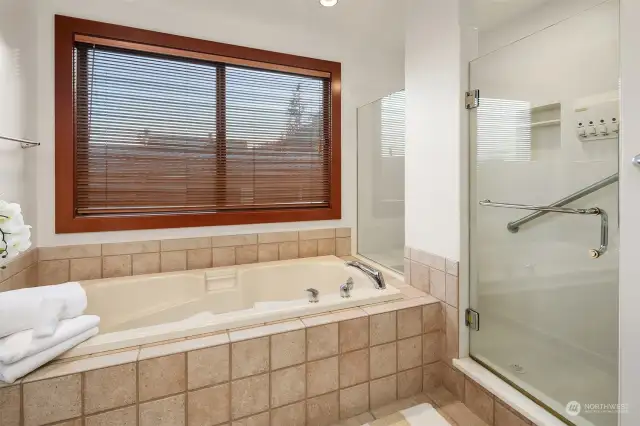 The primary spa bath includes a deep soaking tub and nearby shower.