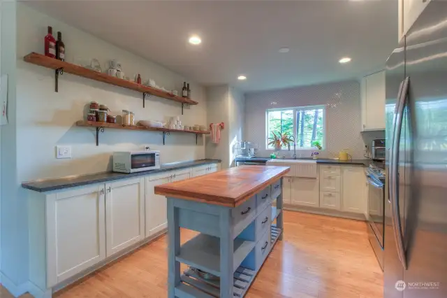 The kitchen has plenty of space for multiple cooks and a nice view from the kitchen sink.