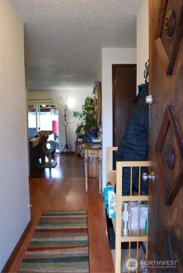 7710 Hardwood laminate  throughout entry, kitchen, and living room.