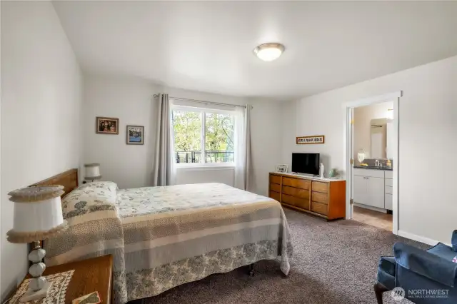 Primary bedroom suite with full bath and walk-in closet.