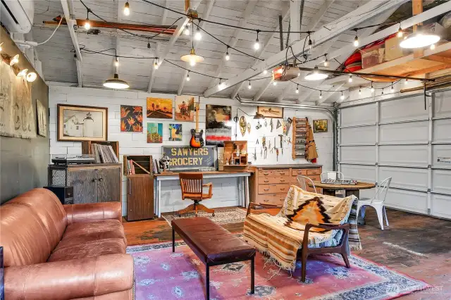 Welcome to the speakeasy garage space. Note the wooden car decking floors and the mini-split. Who puts a mini-split in their garage? Such a magical space.