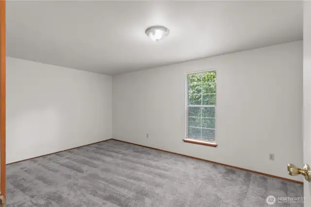 The bedroom on the upper level of Unit A. It includes a large closet.