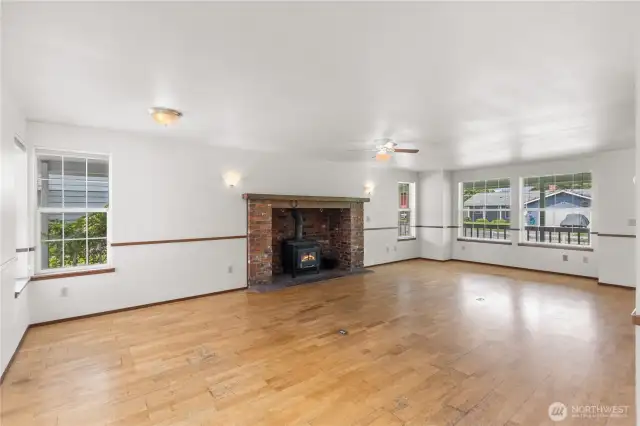 The very spacious living/dining room in Unit A includes the beautiful masonry fireplace with wood burning stove and large windows to provide welcome natural light.