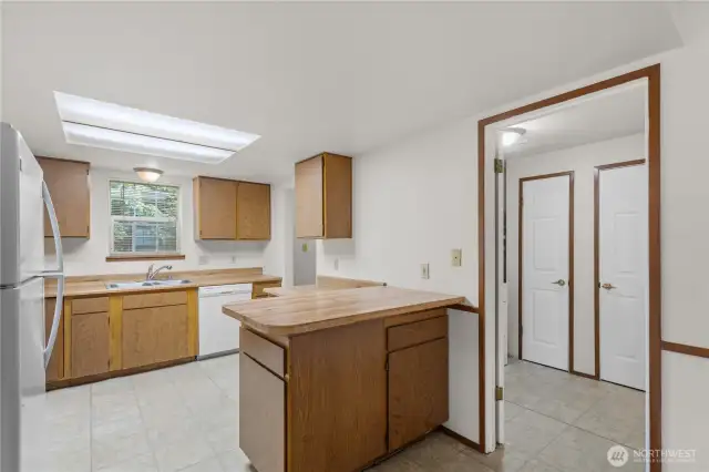 Generous cabinetry and work space in the kitchen, which is adjacent to the laundry room and two closets.