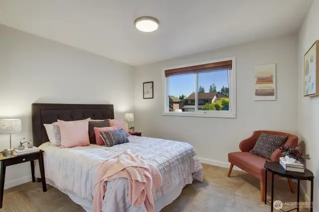 Bedroom 2 of three. The upgraded vinyl windows with wood blinds make the room light and bright or private and shaded. Same fresh paint and new carpet as the other two bedrooms.