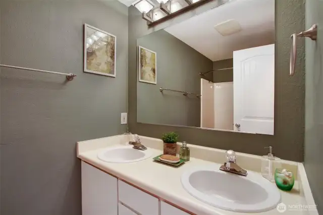 Hallway bath with cream and evergreen paint colors! Dual sink vanity can make sharing easier :)