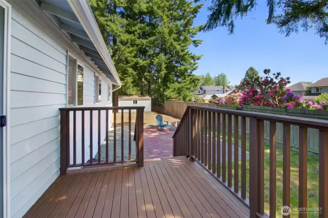 This deck is fresh and easy. Maybe the BBQ stays up here, close to the kitchen? The lower patio is ready for larger groups of friends, table, chairs, maybe a fire feature?