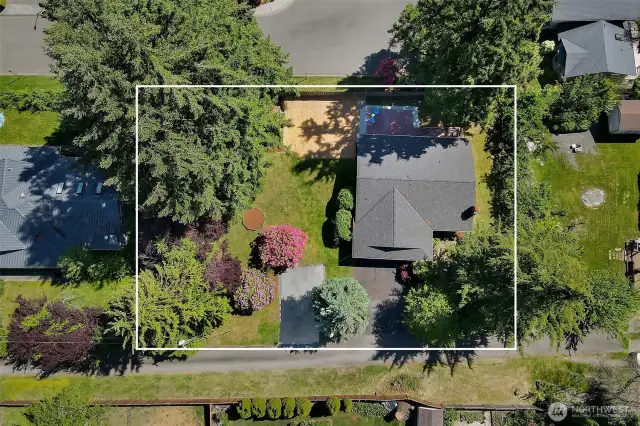 From above, you can see the house, front driveway, RV parking pad, octagonal flower bed, woodchip area, back patio and deck. This angle shows where the larger trees are, at the outside edges of the property. What's not to love?