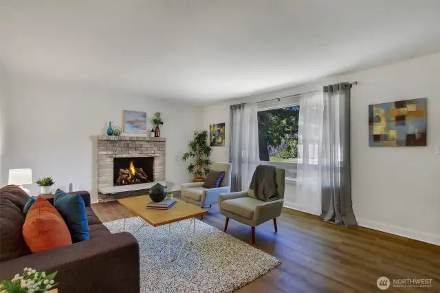 Charming fireplace for cold nights, and a big front window to watch the birds and squirrels...your own natural oasis close to the city