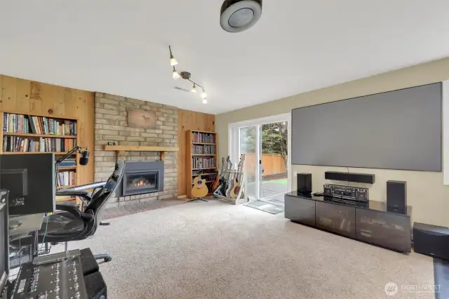 Daylight basement family room with built in projector. Gas fireplace.