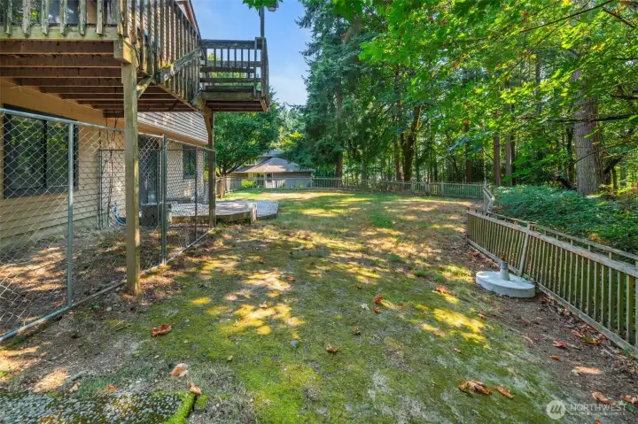 Back yard and deck with dog run.