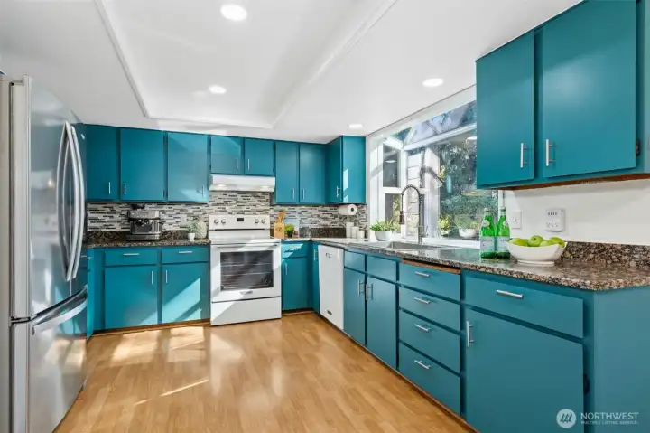 Bold turquoise cabinets add a modern touch.