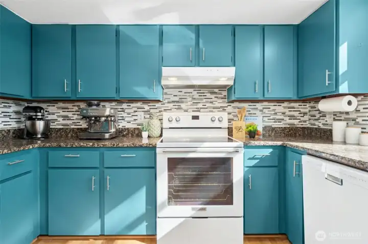 Updated stainless and white appliances complement the modern kitchen design.