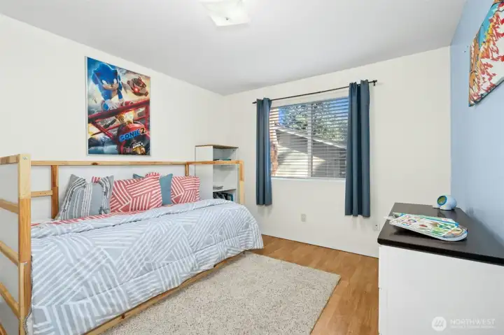Sunny bedroom with soft blue accents and natural light.