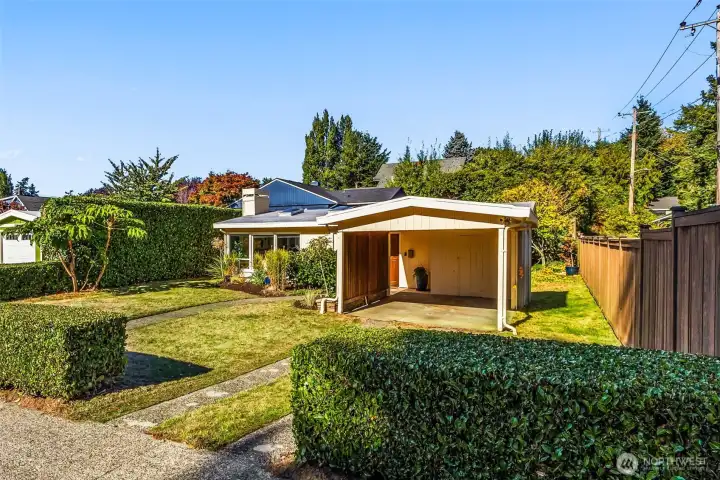 Carport is wide and walk to the front door is mostly covered.  Long driveway offers additional off-street parking.
