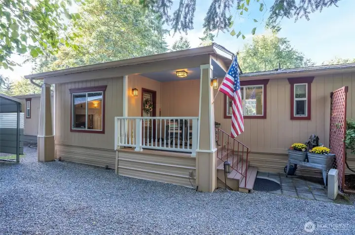 The covered front porch creates a charming and welcoming first impression.