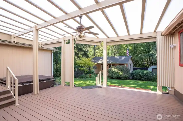 Relax on the spacious Trex deck with hot tub, taking in views of the backyard and the distant studio/flex space. It feels like your own private country retreat.