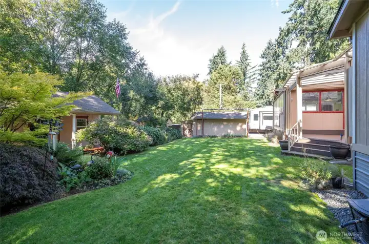Breathtaking side yard views of the main home and studio/flex space, set among beautifully maintained landscaping.
