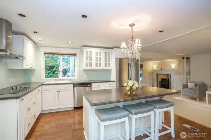 The stunning kitchen boasts a perfect island—ideal for quick bites or catching up with guest.