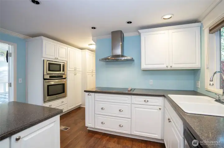 Enjoy another perspective of the kitchen, highlighting the stunning cabinetry that continues down the hall.