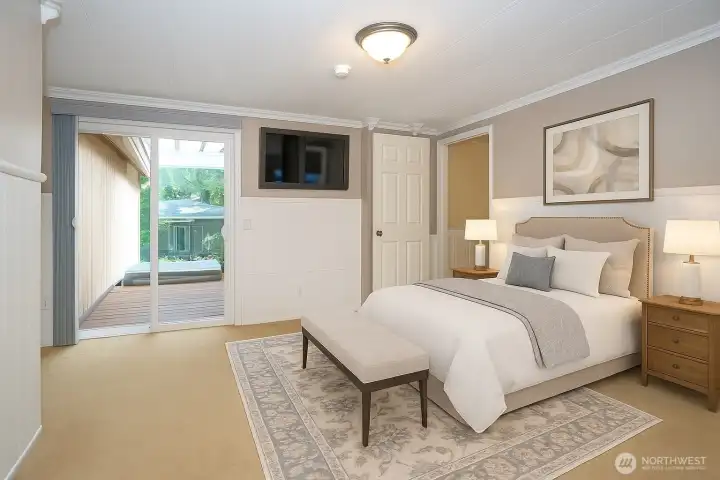 Spacious primary suite with sliding doors leading to the covered deck, virtually staged to showcase its potential.
