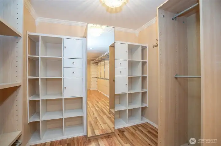 Spotlight on one end of the expansive walk-in closet, featuring ample storage and organization space.