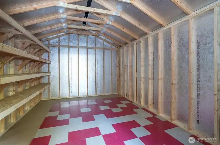 One of the multiple outbuildings - 16x8 featuring insulated flooring and shelving that spans the entire wall.
