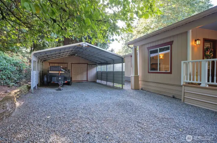 Additional carport for two cars with extra storage space.