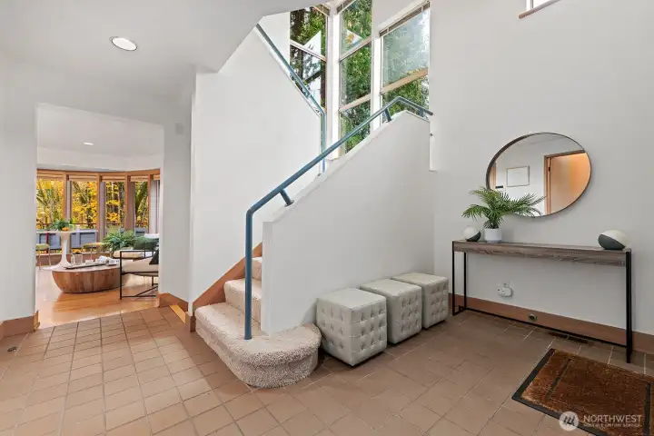 Tiled entry with an open staircase to the second floor.