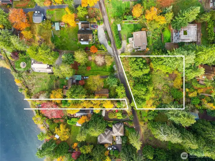 While the white boundary lines are only approximate, this gives you an idea that we're selling two lots together.  The main building site on the East Side of Olympus Beach Rd and a 15' med-high bank wft flag to the West.