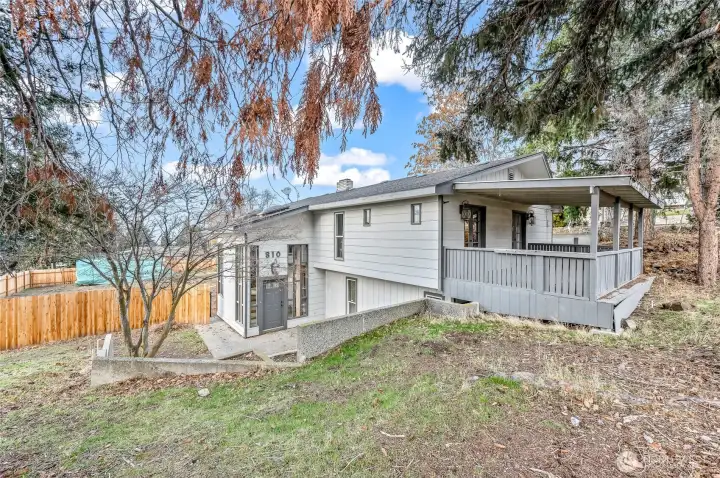 Welcome home! Exterior view of front entrance, fenced back yard and private patio off primary.