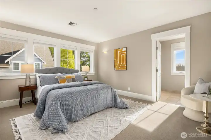 The upper-level primary bedroom suite is spacious and bright with a deep closet (not shown) and an ensuite bathroom.