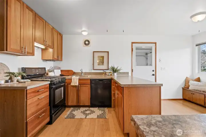 The kitchen has beautiful cherry shaker cabinets and a built-in nook for a table, or the kitchen can be expanded.