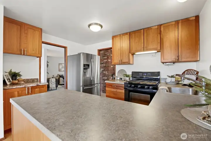 The kitchen has a lot of storage space, including a pantry (to the left) by the eating nook.